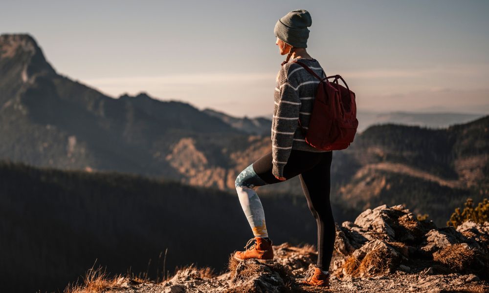 Hiker wearing thermals and backpack while exploring rugged mountains with thermal weight differences explained