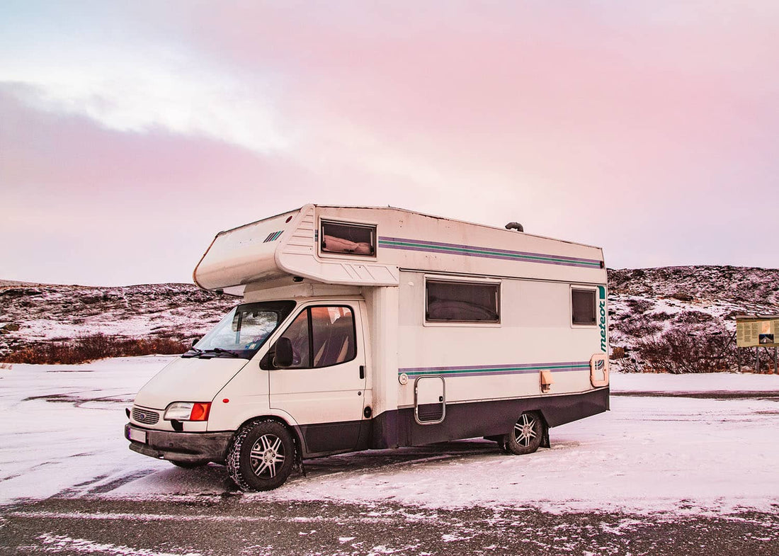 A winter RV campsite setup showing a parked RV surrounded by snow, ideal for learning how to set up a winter RV campsite.