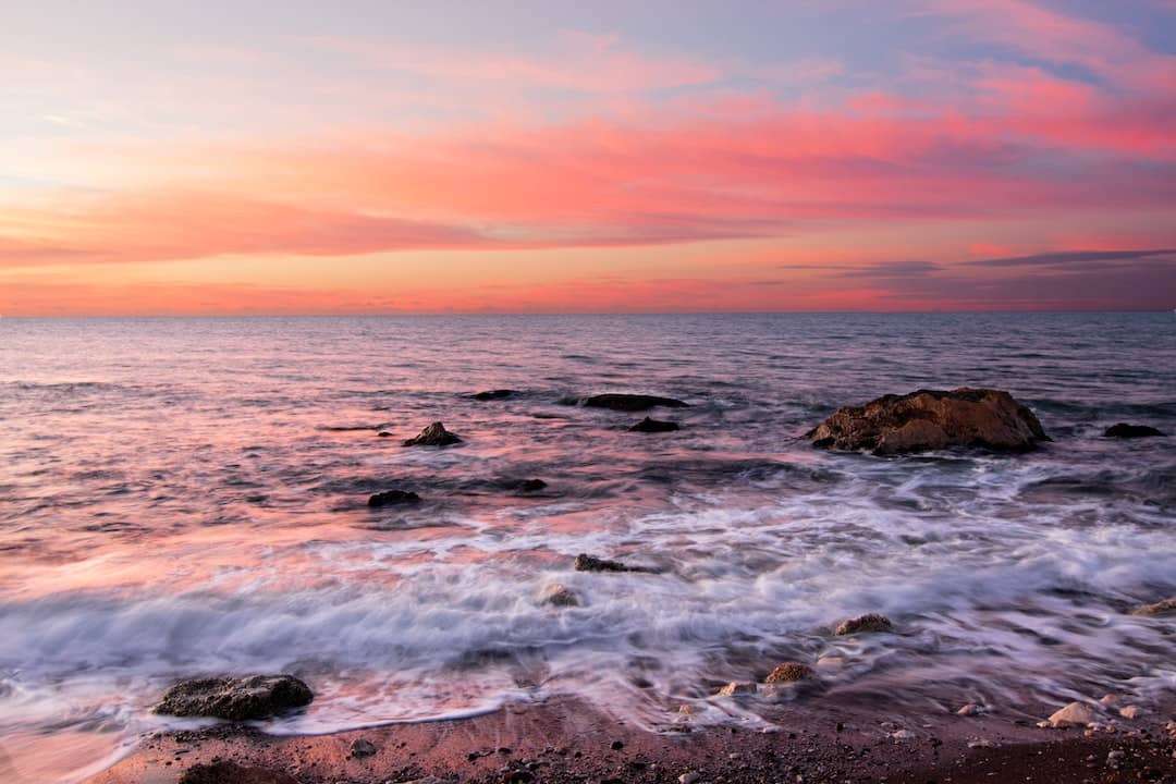 Tranquil ocean view at sunset, ideal for fathers seeking adventure in performance thermal underwear for men