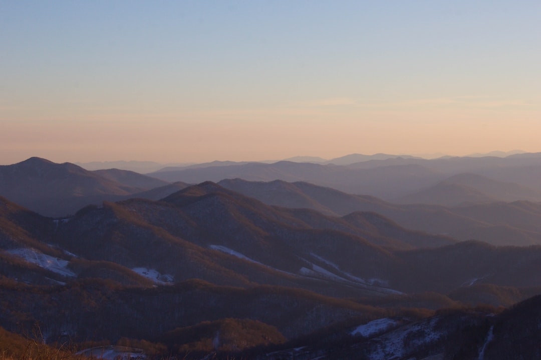 Stunning mountain landscape at sunset showcasing the best base layers for cold weather fishing