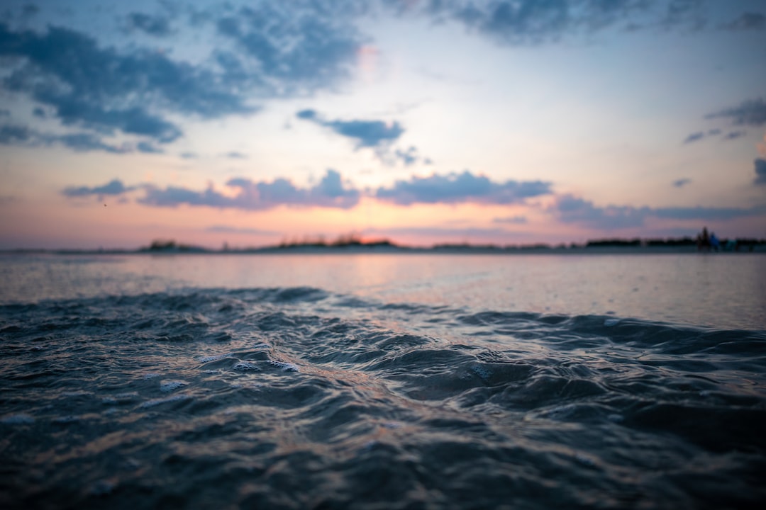 Scenic view of calm ocean water at sunset, showcasing tranquility and natural beauty
