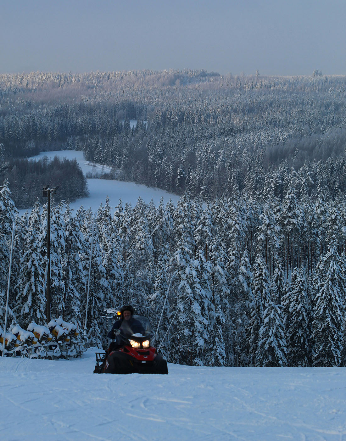 Snowmobile with snowy trees in the background Photo by Anne Nygård on Unsplah
      