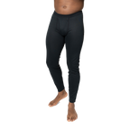 Polarmax black base layer pants for men modeled on a standing man with bare feet against black background