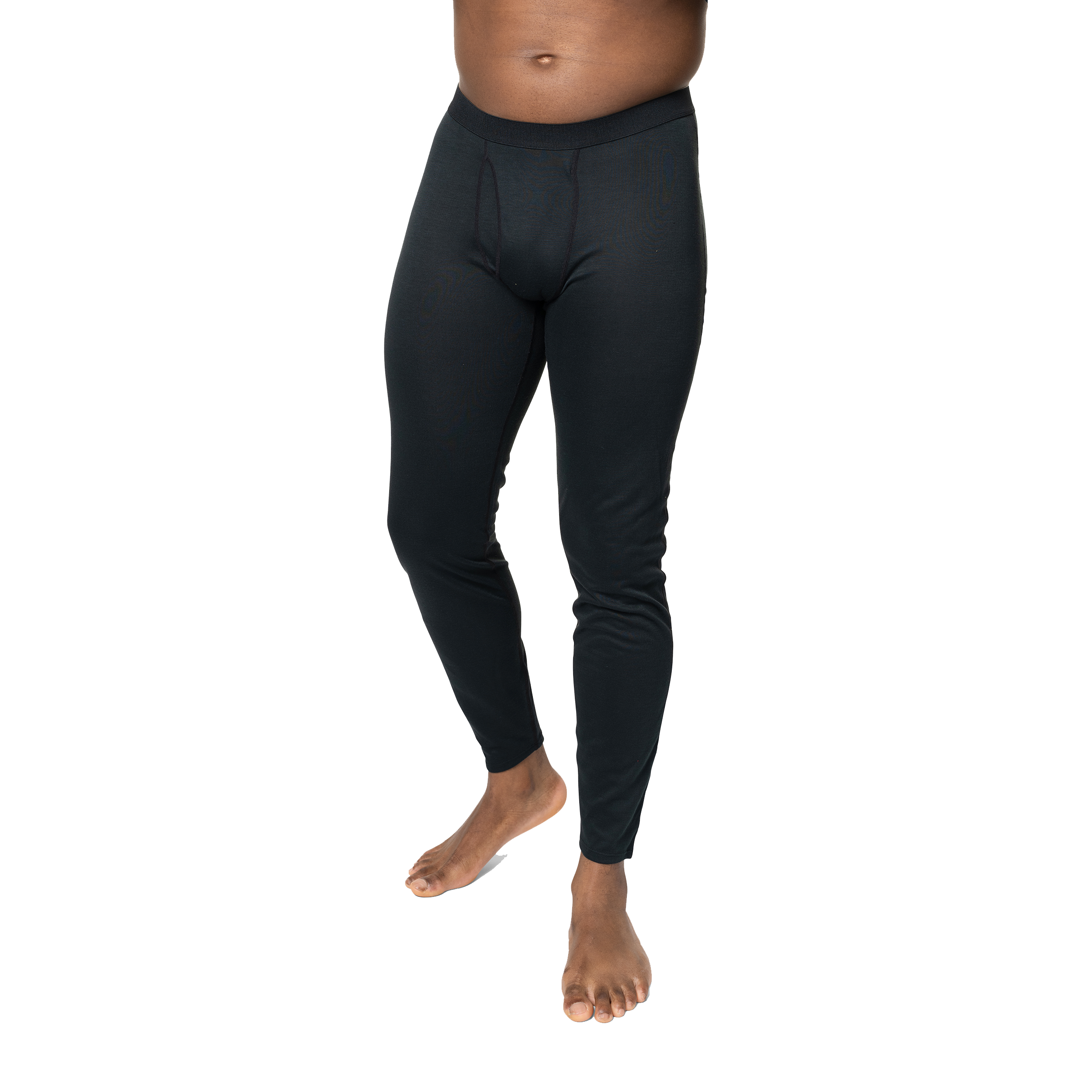 Polarmax black base layer pants for men modeled on a standing man with bare feet against black background