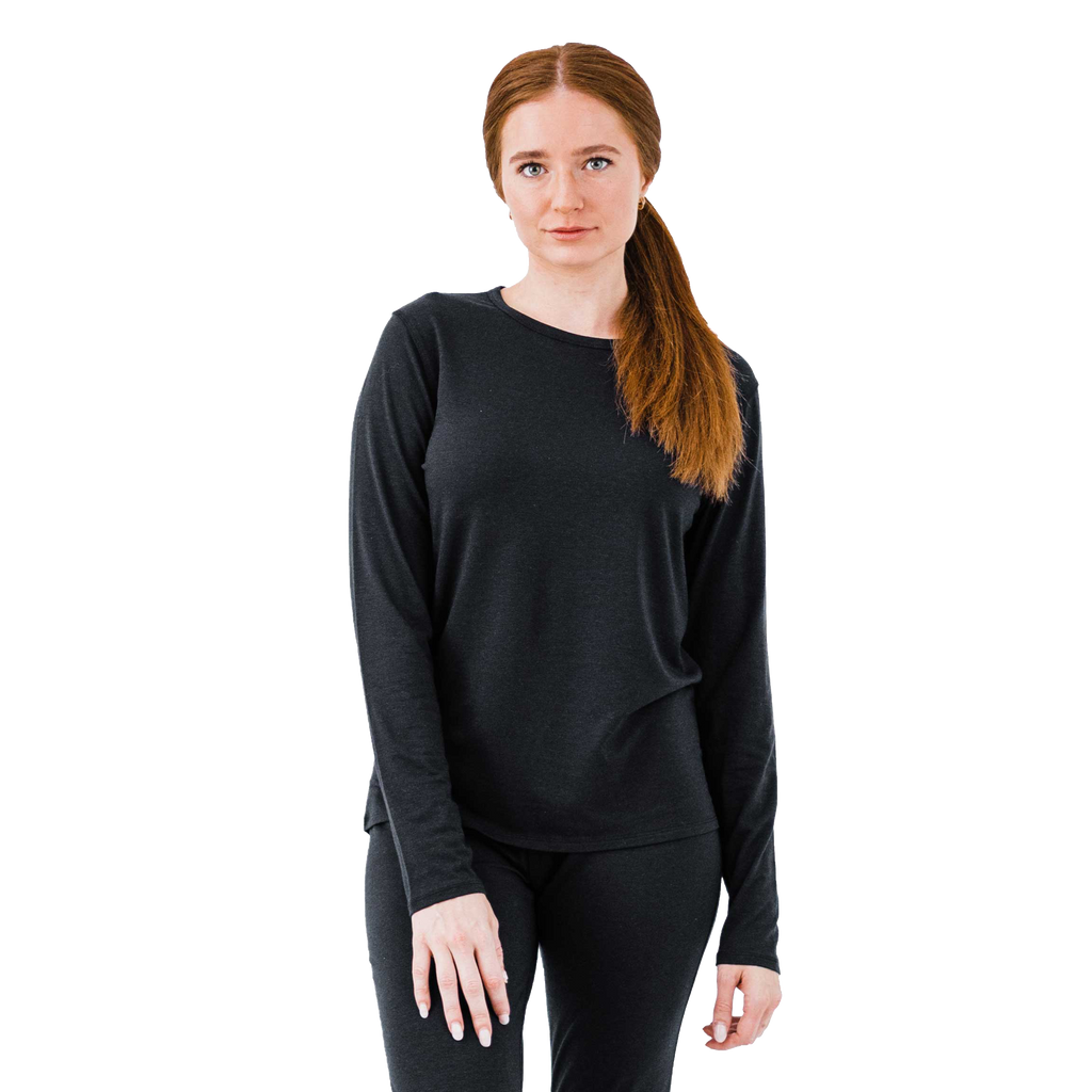 Model wearing a lightweight merino wool top in black, perfect for cold weather as a base layer for warmth and comfort